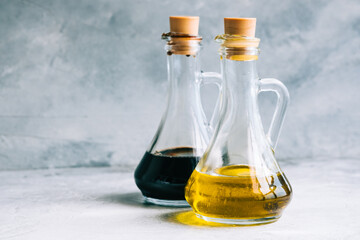 Obraz na płótnie Canvas Olive oil and balsamic vinegar in bottles on the table. salad sauce