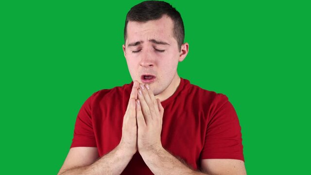 man sneezes on green screen