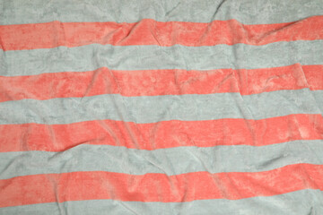 Crumpled striped beach towel as background, top view