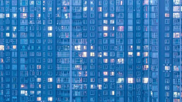 Closeup evening to morning timelapse of Beijing apartment building. Chinese crowded city with lights turning on and off at midnight. Fast paced modern Asian night-scape time lapse in urban metropolis.