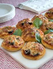 Pizzettas With Napkins and Paper Plates