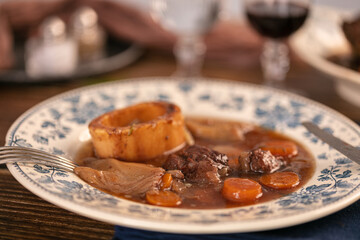 Well-cooked beef shank in wine sauce served in an antique plate