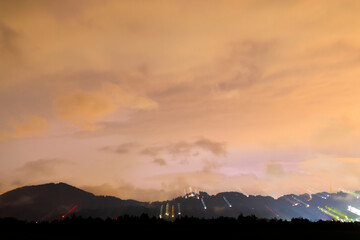 Night covered with clouds, storm and rain on the horizon light sweep, paint with light in the darkness of the city.