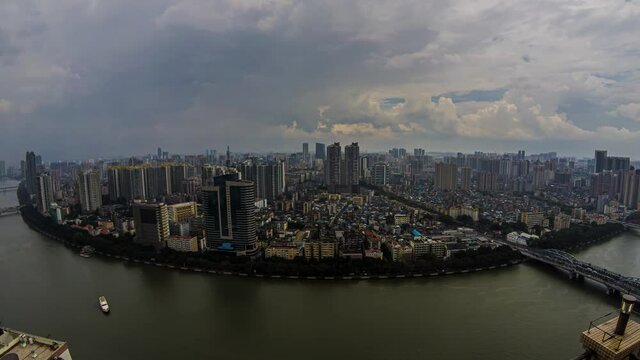 Day timelapse of rainstorm over huge metropolis. Moving storm clouds and sun over large modern city in China. Populous river city cloudy rainfall daytime.