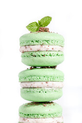 Homemade mint chocolate chip macarons with a mint buttercream filling stacked on top of each other © Nicole Cook