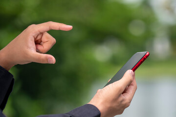 Man Hand hands holding smart phone blur nature background, people use smart phone for contact education, online marketing, business, online technology.