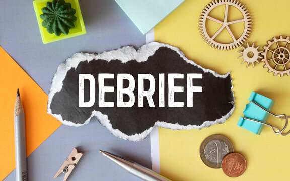 debrief word in a dictionary. debrief concept.