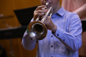 Obraz premium Kid playing trumpet musical instrument bugle close up background image