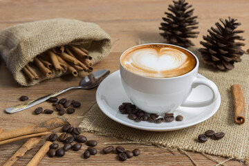 Cup of black coffee with smoke on wooden table