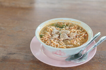 pork in a bowl of noodles