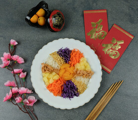 Chinese style raw fish salad. Prosperity Toss for Children. The children are not left behind, they are served without the fish only. Colorful vegetables, peanuts, fritters. Chinese word is "fortune"