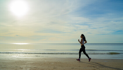 women running on the beach at morning with beautiful sunrise