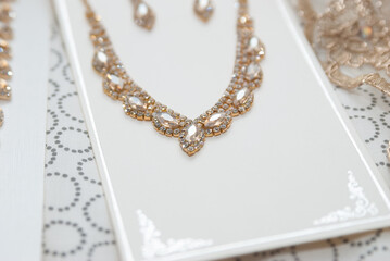 closeup of golden necklace and earrings