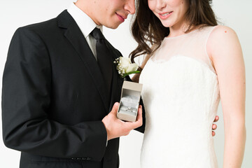 Attractive couple putting on their wedding bands