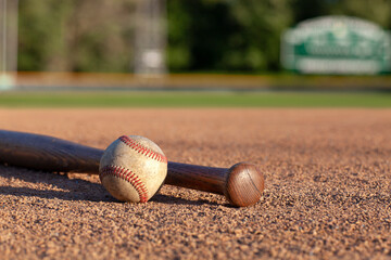 Baseball and bat low angle view on a baseball field