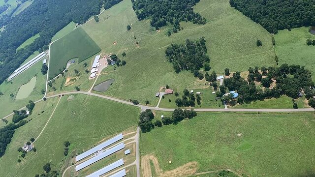 Aerial shot of chicken sheds and farms on green landscape, North Carolina, USA