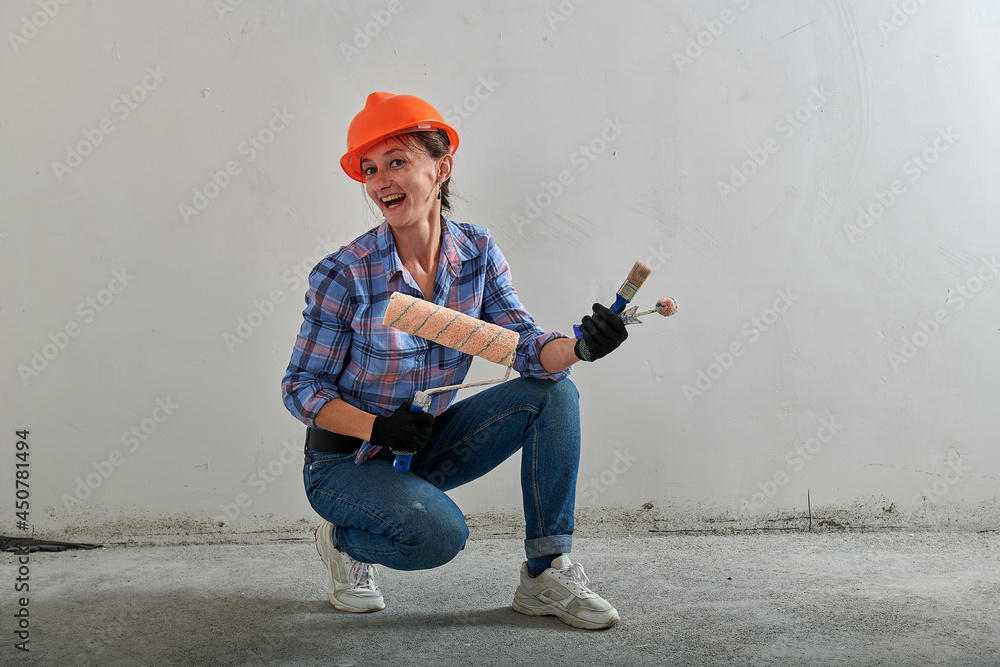 Wall mural construction helmet on a repairman in jeans