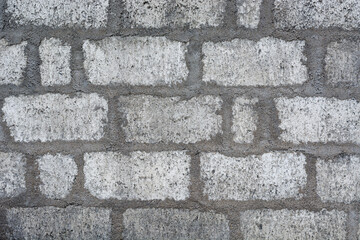 Obraz premium concrete wall with cement blocks and plaster, light gray mortar brick layers surface, masonry work wallpaper, background, texture