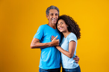 Father and afro daughter smiling on yellow background. father's day concept