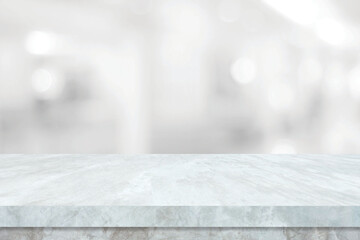 Empty white table top, counter, desk over blur perspective store with bokeh light background, White...