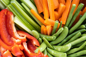 A close up rainbow of healthy fresh organic vegetables cut up into strips ready to be eaten