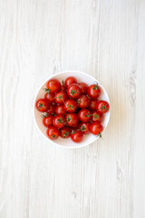 Fresh Red Organic Cherry Tomatoes in a Bowl, top view. Flat lay, overhead, from above.