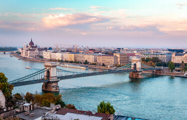 Fototapeta na wymiar The river Danube with tourboats, the Chain Bridge and the Pest skyline in Budapest, Hungary. Photo taken in the evening, from Buda Castle.