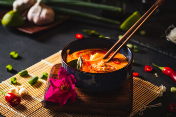 Coconut soup with shrimps and rice pasta. Hot bowl of exotic soup.