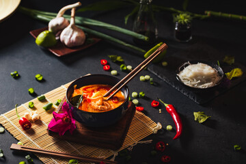 Coconut soup with shrimps and rice pasta. Hot bowl of exotic soup.