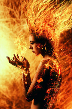 Young woman with burning hair holds flames in her hands. The woman's skin is charred, cracked and burning. Unusual portrait with a burning girl, reborn as a phoenix