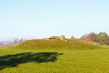 Fototapeta premium Megalith grave on a hill in a field