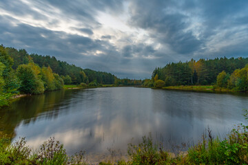 Fototapeta na wymiar A small forest lake at autumn time, Belarus