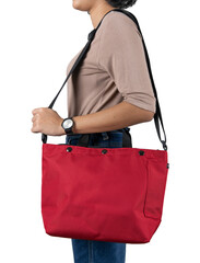 Isolated close up studio shot of female model in brown long sleeve shirt and jeans stand hanging big red multipurpose unisex traveling sport folding bicycle bag on shoulder on white background