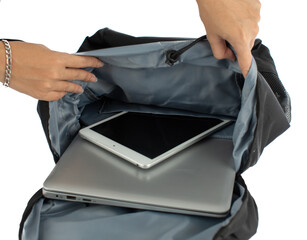 Isolated closeup studio shot of female hands opening canvas fabric backpack putting touchscreen...
