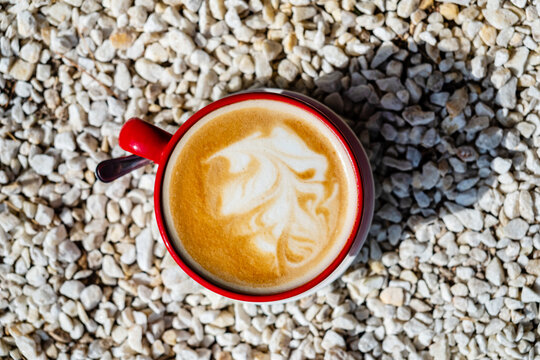 cup of cuppuccino in the red cup - Powered by Adobe