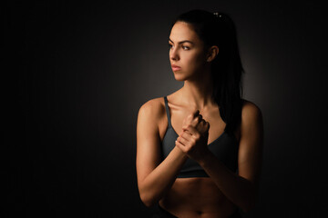 fitness young woman with a healthy toned body, stretching arm for warming up