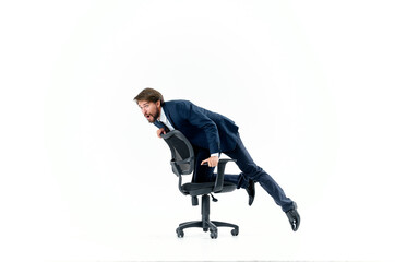 Cheerful man rides in a chair office manager studio