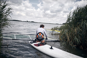 Windsurfer surfing on a windy summertime day at the river.