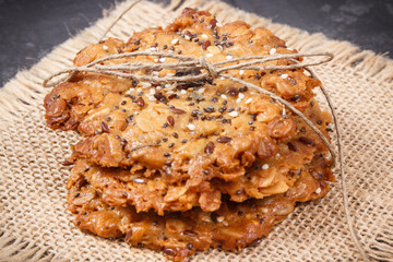 Fresh baked oatmeal cookies on jute canvas. Delicious crunchy dessert