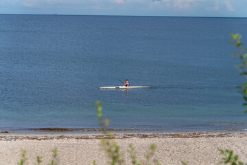 Fototapeta na wymiar Man in his Kayaks, kanoeing in the sea near Aarhus