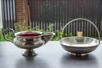 Beautiful gold-plated cup with tea stands on the windowsill