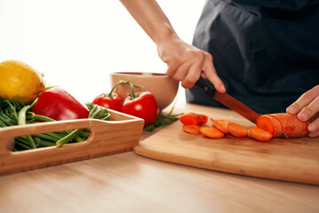 Obraz na płótnie Canvas slicing carrots in the kitchen cooking salad health vitamins