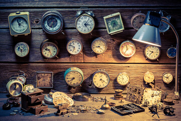Fototapeta na wymiar Watchmaker's workshop with vintage clocks. Ancient watchmaker's workshop.