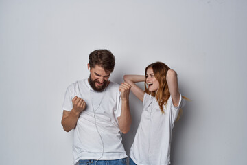 man and woman in white t-shirts are standing next to friendship fun light background