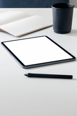 Mockup blank screen tablet with pen on white top table, vertical view.