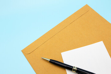 document envelope and paper with pen to sign contract on blue background flat lay