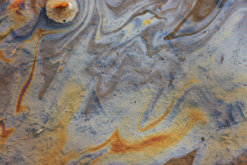 puddle gasoline background, wet oil multicolored rainbow pollution spill