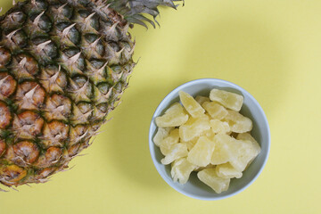 Fresh and Dried Pineapple on yellow Background Closeup