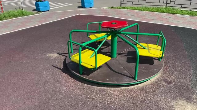 green and yellow color children carouse  on playground