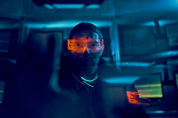 Portrait of a cyber hacker stealing information using a computer.